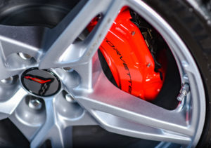 Closeup of 2020 Corvette red brake caliper with a silver rim.