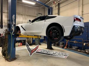 Corvette Being Lowered on Lift After Being Serviced